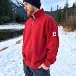 Red quarter zip polo with canada flag logo on left arm.