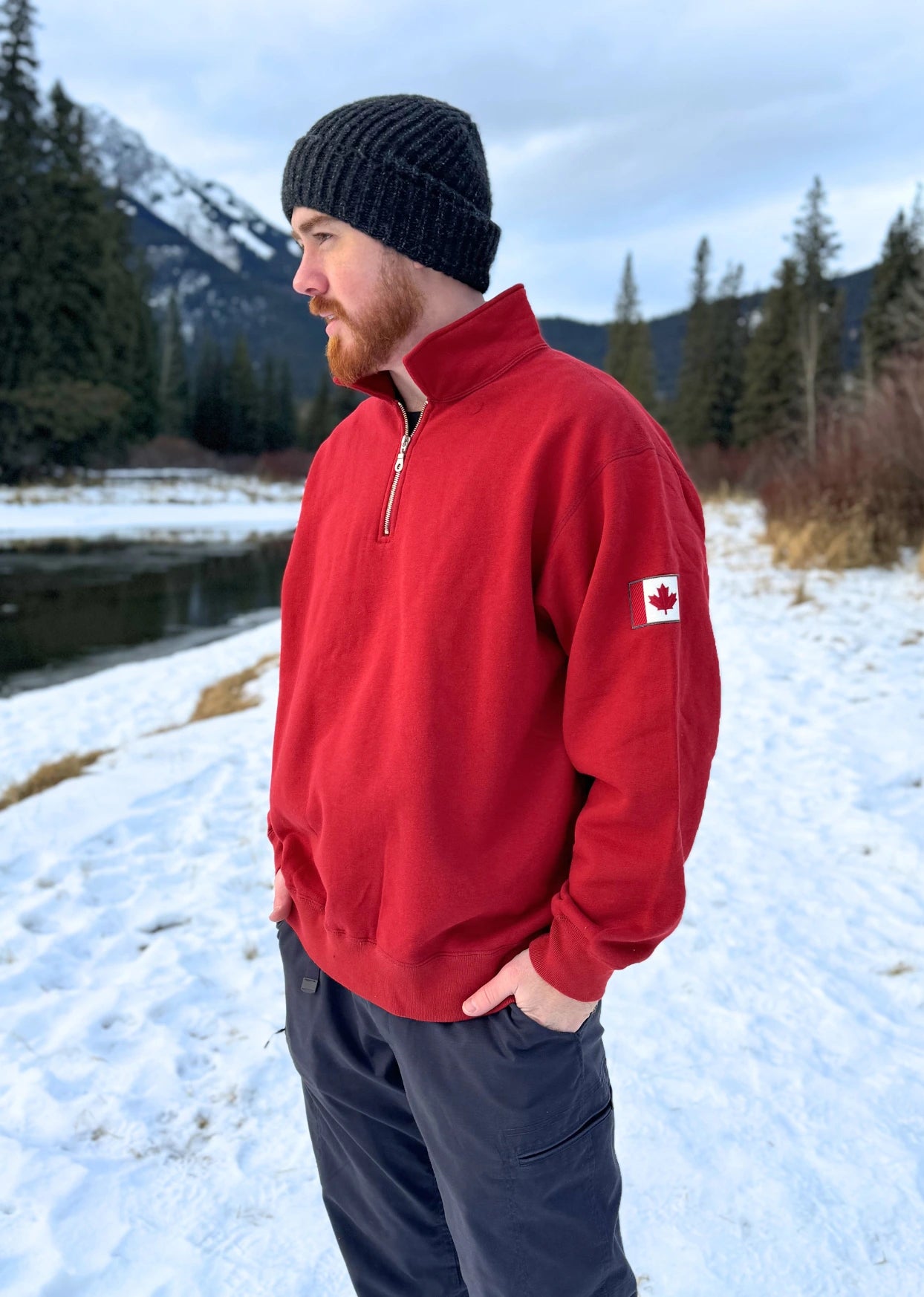 Red quarter zip polo with canada flag logo on left arm.