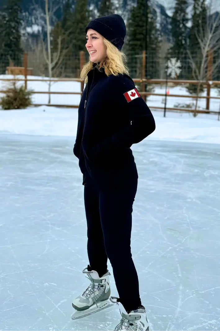 Black full zip fitted Canadian Jacket with Canada flag on left arm. Girl on ice rink