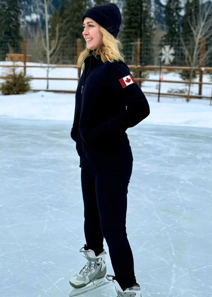 Black full zip fitted Canadian Jacket with Canada flag on left arm. Girl on ice rink