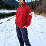 Red quarter zip polo with canada flag logo on left arm.