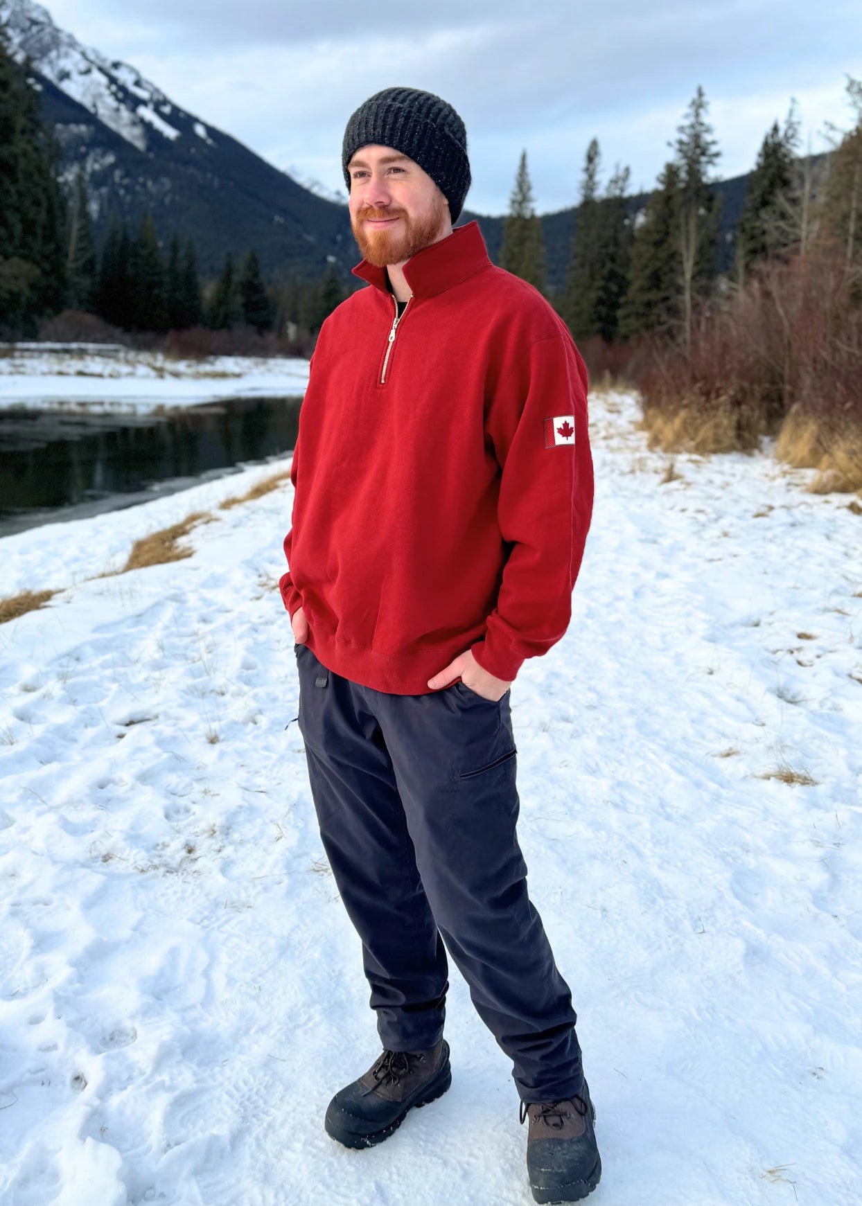 Red quarter zip polo with canada flag logo on left arm.