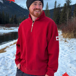 Red quarter zip polo with canada flag logo on left arm.